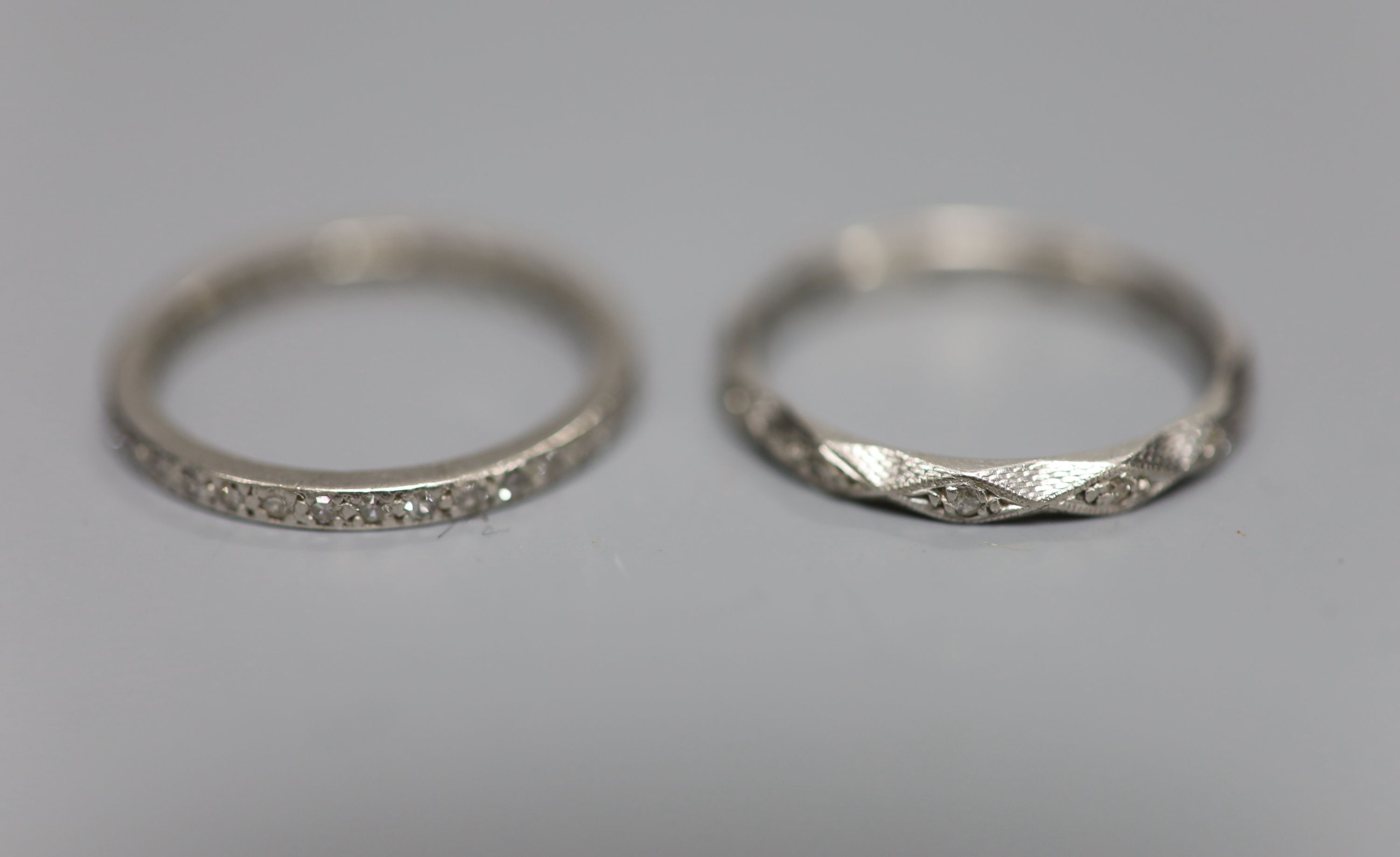 Two white metal and diamond chip set full eternity rings, one stamped platinum, size N,